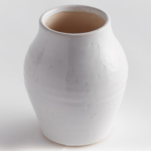 Subtle throw lines and natural textures from the firing process give this terracotta vase a vintage look. Finished in a...