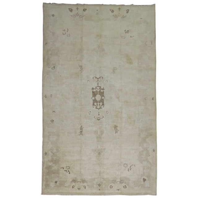 Midcentury Turkish Oushak predominantly in a gray tone Measures: 3'8” x 6'6”.