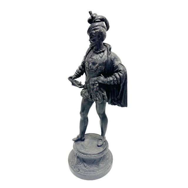 A charming tabletop Spelter Cavalier statue captures the essence of an 18th-century French gentleman, adorned in a flowing...