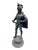 A charming tabletop Spelter Cavalier statue captures the essence of an 18th-century French gentleman, adorned in a flowing...