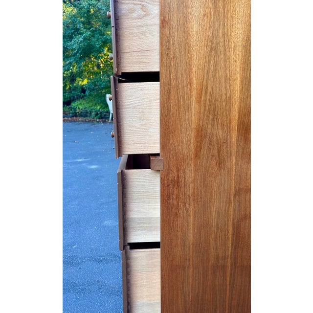 Beautiful vintage Mid-Century Modern highboy dresser featuring a striking architectural design, warm wood grain, curved-...