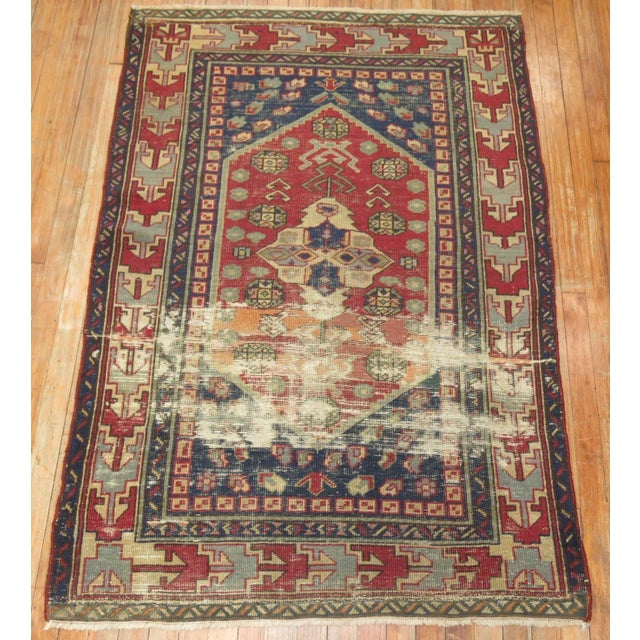 One of kind, hand-knotted Mid-20th-century Turkish throw size oriental rug with a quirky distressed traditional motif....