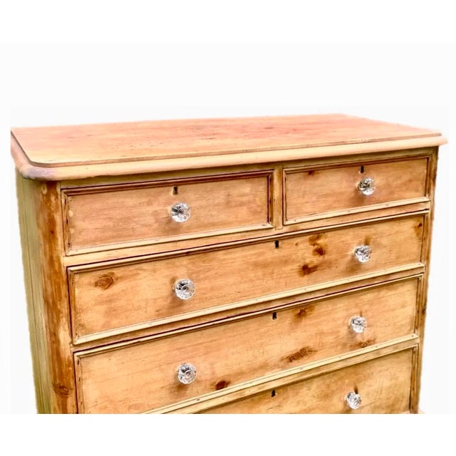 Handsome scrubbed pine chest of drawers in a two over three configuration. Dowel construction, dovetailed drawers with...