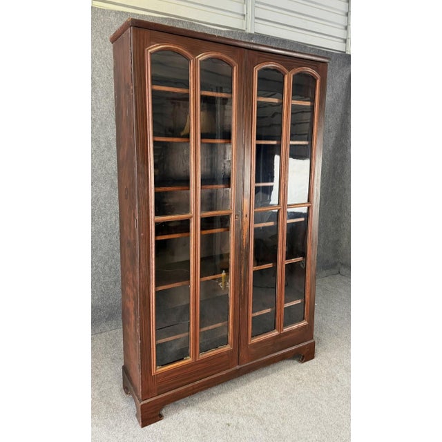 This monumental 19th century two-door bookcase retains its original painted grain finish, adding depth and authenticity to...