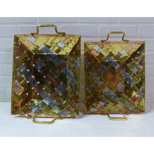 Gorgeous pair of stacking mid century modern design metal weave baskets. Woven from brass, aluminum and copper in the...