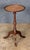 A fine English wine or cocktail table of mahogany from the Edwardian era, featuring a raised edge around the circumference...