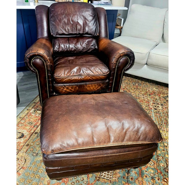 This a lovely chestnut brown worn library chair that is uniquely compact enough to use as a comfy lounge library club...