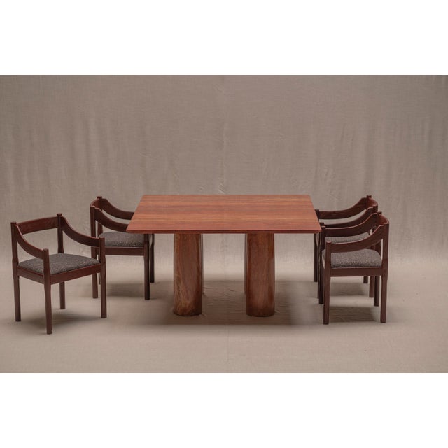 Architectural dining table designed by Mario Bellini, model Il Colonnato, crafted in richly textured orange travertine....