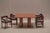 Architectural dining table designed by Mario Bellini, model Il Colonnato, crafted in richly textured orange travertine....