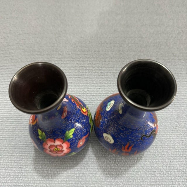 Make a magnificent statement in your home with this exceptional Pair of Vintage Cloisonné Enamel Dragon and Phoenix Vases....
