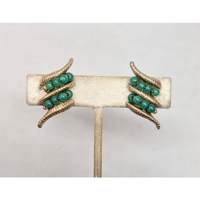 Goldtone two lines of faux-jade beads butterfly clip back earrings. Marked "NAPER PAT. PEND." on the clips. Made in 1964....