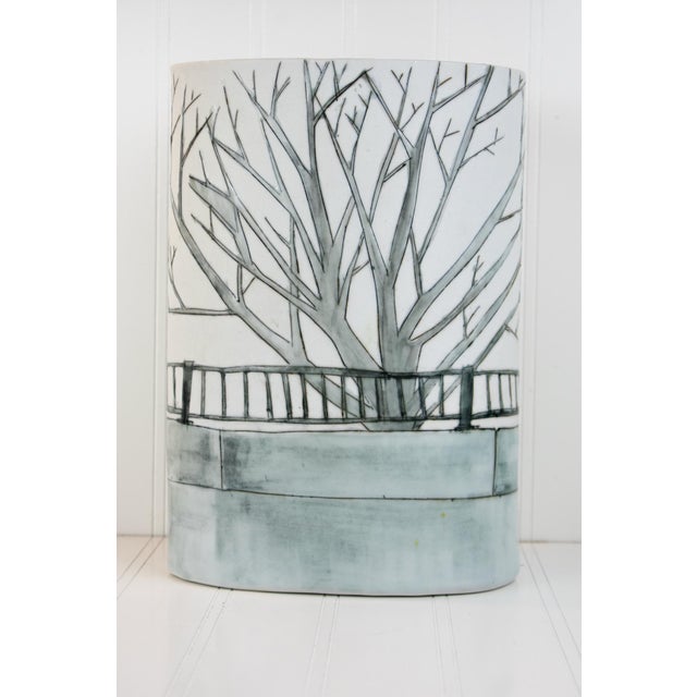 This hand-painted studio pottery vase features an elegant, tall sleeve form with a distinctive oval (elliptical) profile....
