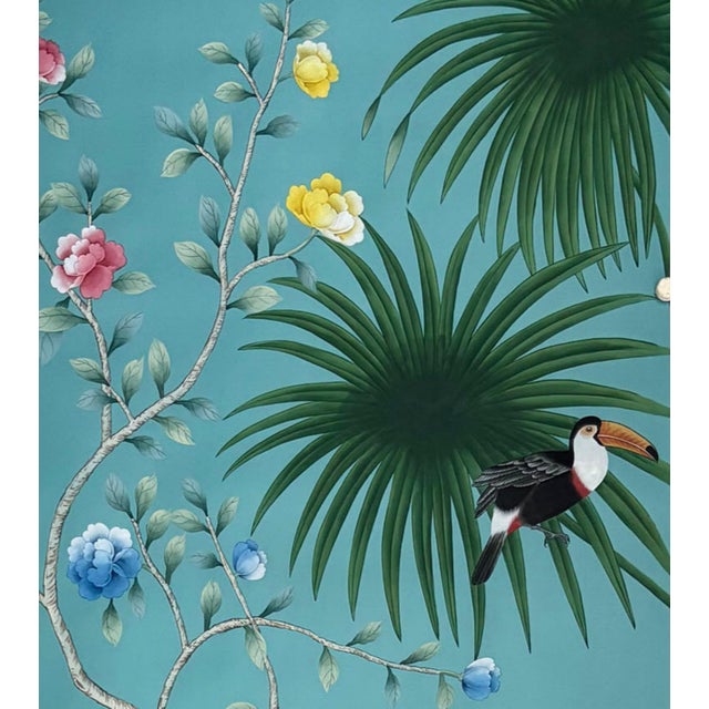 Meticulously hand-painted chinoiserie mural set with elegant teal backdrop, featuring fan palm trees, blossoming...