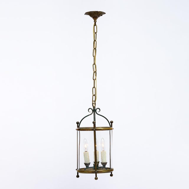 Petite brass lantern from France made with a solid brass structure. The simple lines and curved forms are reminiscent of...