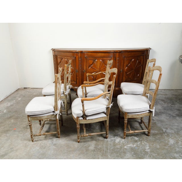 A set of six French wooden dining room chairs from the 19th century, with four sides, two arms, carved guilloche motifs...