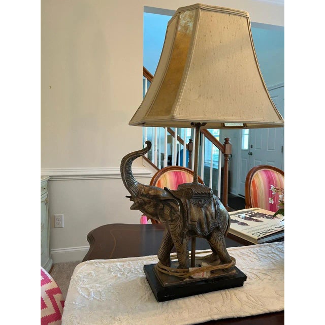 The handsome elephant lamp has a silk and Capiz shell shade. His tusks need to be glued on but they’re taped to the base....