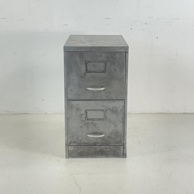 Vintage stripped and polished steel slim 2 drawer filing cabinet. The interior is in its original painted finish. As it's...