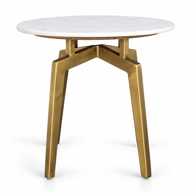 Round white marble top side table with four brass finish iron legs. Each may vary in natural marble differences.