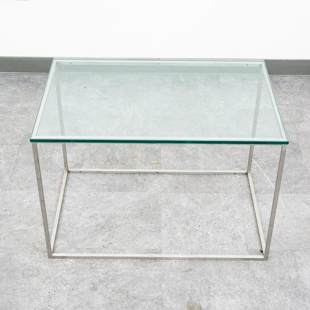 Unique heavy metal and glass table. Unknown maker. High quality and well designed.