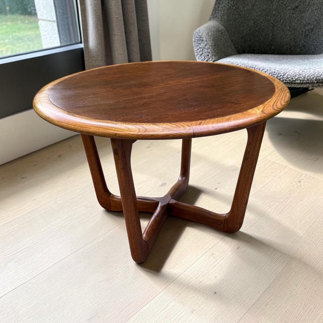1968 Lane Perception round side / end table. Original walnut veneer covers the center of the top, while the edges are...