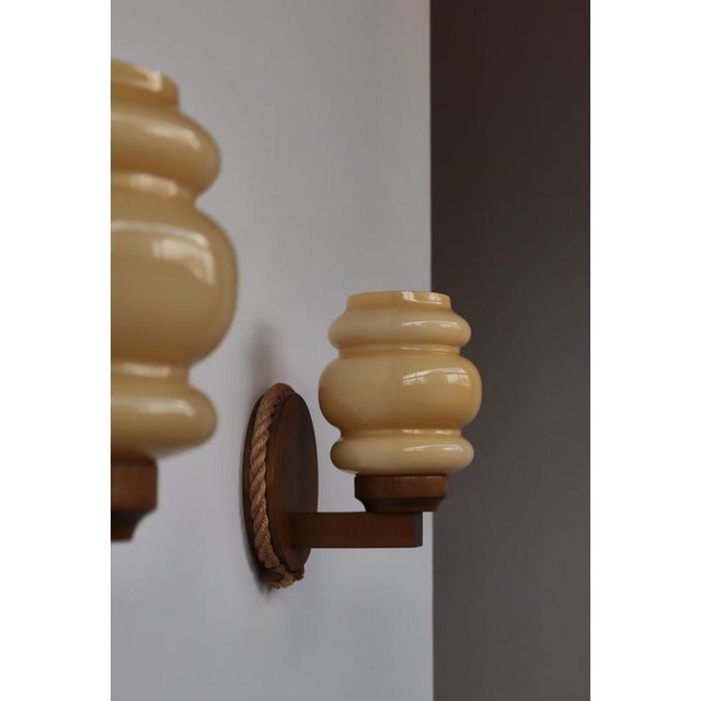 A rare and beautifully crafted pair of Scandinavian Modern wall lamps manufactured by Markslöjd, Sweden, during the 1970s....