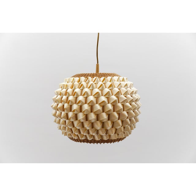 Rare and lovely decorative Mid-Century Modern pendant lamp. Designed and manufactured probably in Italy, 1960s. The lamp...