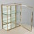 A French Art Deco hanging wall vitrine with solid brass frame, mirrored back and glass panes. Two adjustable glass...