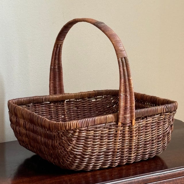 A charming little woven wicker garden trug-style basket featuring a deep, gently rounded body with pretty French randing,...