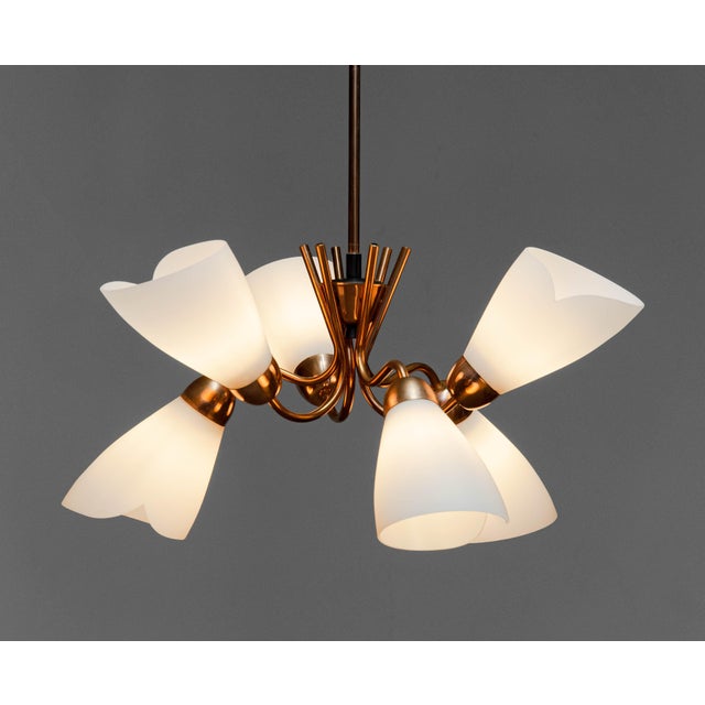 Elegant mid-century chandelier from Sweden, dating to the 1950s, featuring a beautifully sculpted frame in red copper. The...