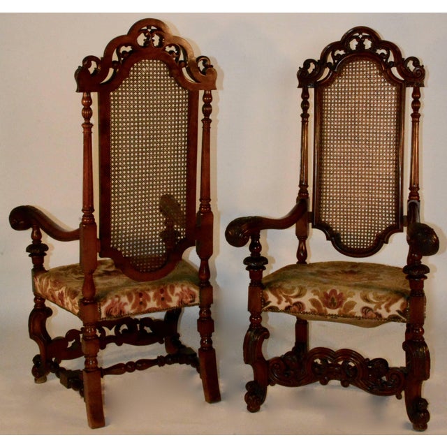 Spanish baroque high back chairs with scalloped top rail with a pierced scroll carved crest. Curved arms with a highly...