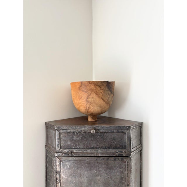 A raw industrial cabinet in fabricated steel with riveted details and turn button closures. This patinated metal corner...