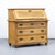 This antique secretary desk dates from around 1850 and features highly decorative, heavily weathered ochre-yellow...