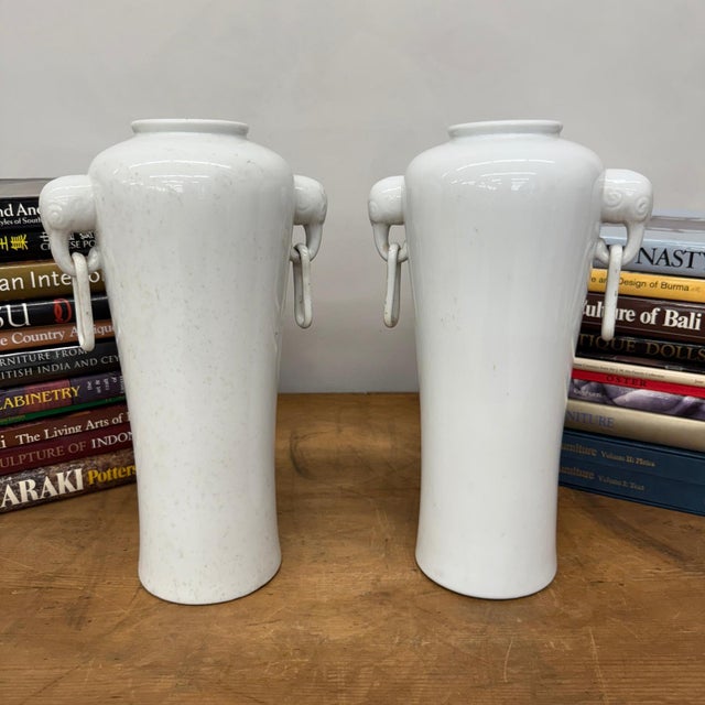 "About This Piece About This Piece These stately ceramic vases are a study in restrained elegance, their smooth ivory-...