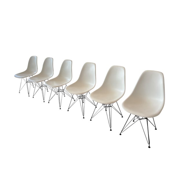 Set of 6 original Vitra Eames DSR chairs in white with black Eiffel bases, designed by Charles & Ray Eames and labelled by...