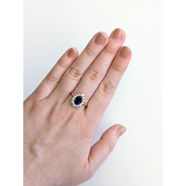 This 1.76 carat Ceylon sapphire ring features a dazzling floral diamond halo and a polished 14k rose gold setting. A true...