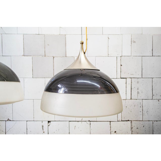 Pair of pendant lamps with matte nickel-plated brass frame, acrylic shade, and white opal glass. Model 1238 Manufacturer...