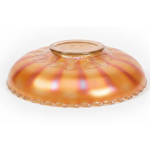 A beautiful antique Dugan carnival glass bowl in the collectible Six Petals pattern, dating to the early 20th century. The...