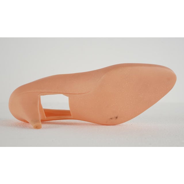 Vintage European pink plastic high heel shoe mold. There is an almost square shaped cut out on the bottom of each one....