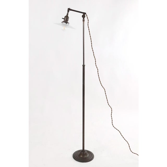 Early 20th century adjustable industrial style brass floor lamp with a disk shade in opal glass. Height of pole is...