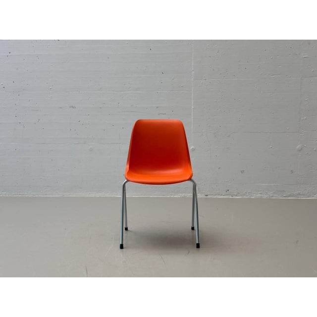 These striking stacking chairs from the europa series were designed by helmut starke and exemplify the functional yet...