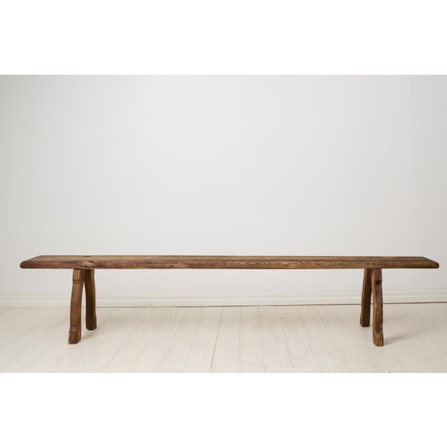Primitive rustic Swedish bench from the early 1800s. Made in northern Sweden from pine, the bench has never been painted...