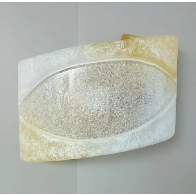 Vintage Italian Murano glass wall lights in amber and frosted white color with an "eye" shape in the center / Made in...