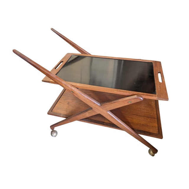 1960s Danish Rolling Reversible Tea Cart by Grete Jalk. Possibly by Poul Jeppesen. The top shelf of the cart is...