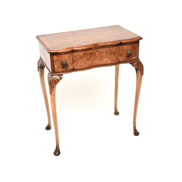 A gorgeous antique burr walnut console / side table in the Queen Anne style. This was made in England, it dates from...