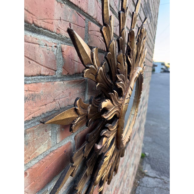 This is a gorgeous vintage mirror! Done in sunburst style, there are two layers of rays made up of individual sun ray...