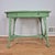 This is a charming antique wicker table with an oval solid wood top. The table is painted a cheerful celery green, a color...
