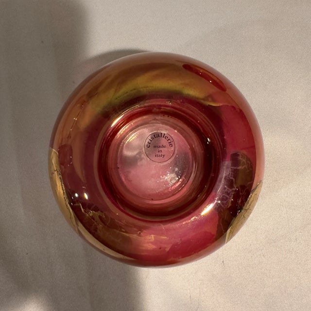 A pair of Cristallerie blown crystal candle holders in ruby flashed crystal with abstract swatches of heavy gold leaf...