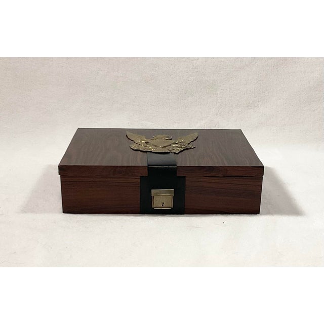 A vintage West Germany rosewood with solid brass accents Men’s jewelry box from the 1960’s. This piece features a military...