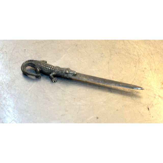 1960s-70s silver alligator letter opener. Excellent condition. Measures 7" long total and 1.5" wide at handle/widest point.