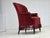 1950s, Danish highback armchair. Red furniture velour, beech wood legs, brass springs in the seat. The chair was...